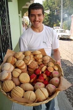 a man holding a basket full of cookies