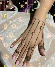 a woman's hand with henna tattoos and crescents on the palm, surrounded by stars