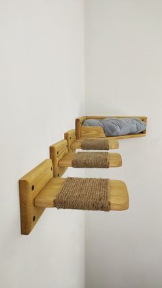 three wooden shelves are hanging from the wall