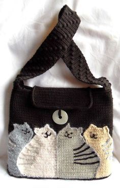 a crocheted purse with cats on it