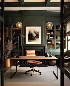 an office with dark green walls and leather chairs in front of a desk that is surrounded by built - in bookshelves