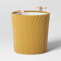 a large yellow basket with two wooden handles