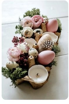 a vase filled with flowers and candles on top of a table