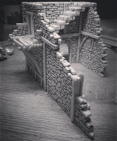 a black and white photo of a building made out of rocks