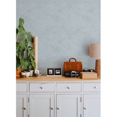 a white dresser topped with lots of different items