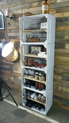 a shelf with several pairs of shoes on it in front of a wall mounted camera