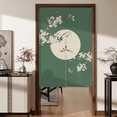 an open door with flowers on it in front of a green wall and wooden floor