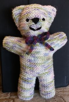 a knitted teddy bear with a bow tie