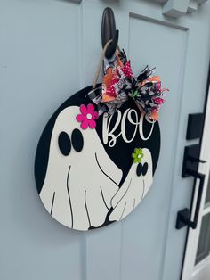 a decorated door hanger with the word boo on it