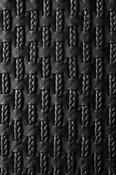 an up close shot of black leather with braiding