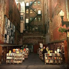 there are many books on the shelves in this alleyway