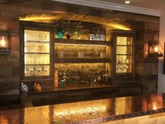 a bar with lighted shelves and bottles on it