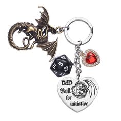 a metal keychain with a dice and a dragon on it