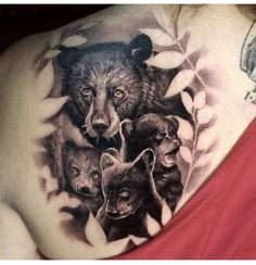 a woman with tattoos on her chest has a bear and cubs tattoo on it's shoulder