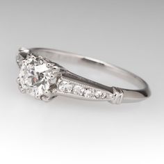 an antique style diamond engagement ring with side stones