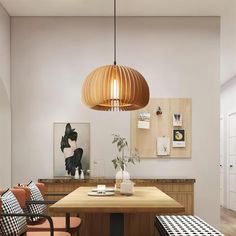 a dining room table with two chairs and a light fixture hanging over it's head