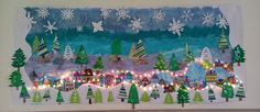 a christmas scene made with paper and string lights