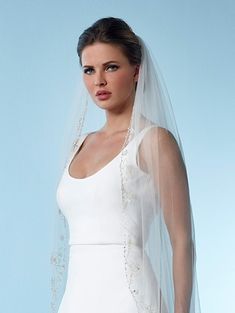 a woman wearing a white wedding dress and veil