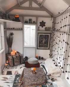 a living room filled with lots of furniture and decor on top of carpeted flooring