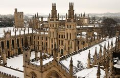 an aerial view of a large building with towers and spires in the middle of snow