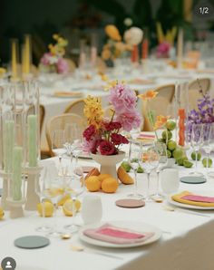 the table is set with flowers, candles and wine glasses for an elegant wedding reception