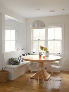 a dining room table with chairs and a bench