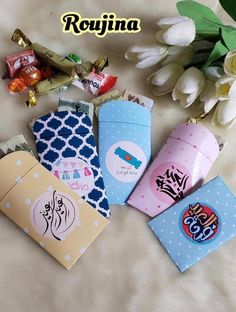 several different types of candy and candies on a white sheet with flowers in the background