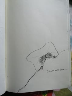 an open book with a drawing of a person holding a bird on it's back