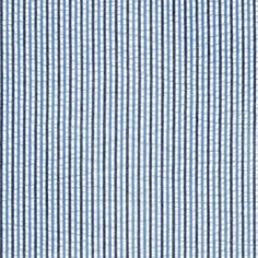 a blue and white striped shirting fabric with small black dots on it's chest