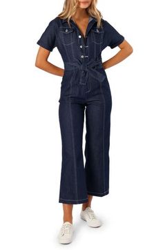 Contrast stitching heightens the utilitarian style of a short-sleeve denim jumpsuit cinched with a matching tie belt. Front button closure Spread collar Short sleeves Chest button-flap patch pockets; front slant pockets; back patch pockets Removable tie belt Unlined 100% cotton Hand wash, dry flat Imported Short Sleeve Denim Blue Jumpsuits With Button Closure, Denim Blue Short Sleeve Jumpsuit With Button Closure, Utility Short Sleeve Denim Jumpsuit With Pockets, Denim Blue Jumpsuits And Rompers With Pockets, Utility Denim Jumpsuit With Short Sleeves And Pockets, Denim Belted Overalls Jumpsuits And Rompers, Utility Denim Jumpsuit With Pockets And Short Sleeves, Blue Short Sleeve Jumpsuit With Tie Waist, Short Sleeve Denim Jumpsuits And Rompers With Button Closure