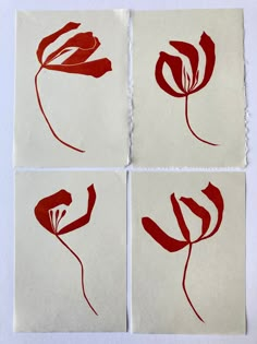 four pieces of red and white paper with flowers drawn on them, all in squares