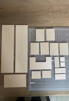 several pieces of wood sitting on top of a table next to a cutting board and ruler