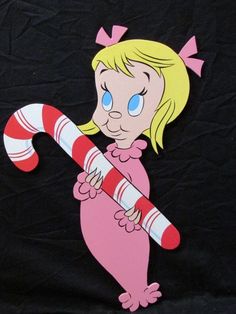 a paper cut out of a cartoon character holding a candy cane on a black background