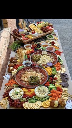 a table filled with lots of different types of food on top of eachother