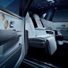 the interior of a luxury car with white leather and silver trims, stars in the sky