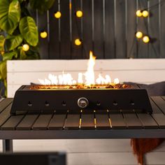 a fire pit sitting on top of a wooden table