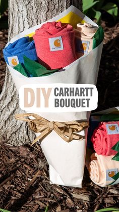 the diy carmartt bouquet is wrapped in paper and tied to a tree