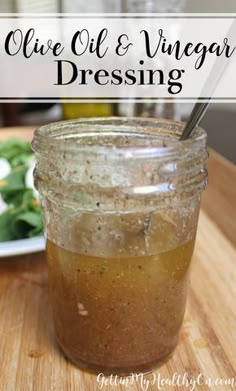 a mason jar filled with olive oil and vinegar dressing