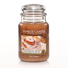 a jar of cinnamon roll yankee candle on a white background