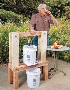 a man standing next to a table with buckets on it