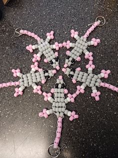 the beaded snowflake is on the floor and ready to be made into ornaments