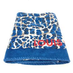 a blue towel with an animal print on the front and red lettering that reads louis