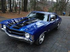 a blue car parked on the side of a road