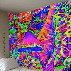 a colorful wall hanging over a bed in a bedroom