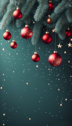 christmas balls hanging from the branches of a fir tree with stars and snow flakes