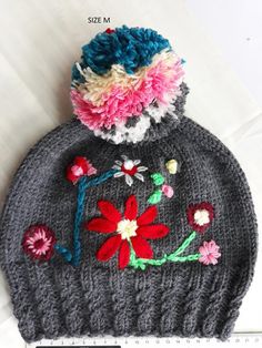 Women's Hats , Embroidered hat, Winter knit hats, Knitted winter caps, Floral embroidery, Pompon bea Knitted Beanie Winter Hat, Gray Knitted Beanie For Winter, Knitted Winter Beanie One Size Fits Most, Winter Crochet Cap Made Of Acrylic Yarn, Acrylic Yarn Crochet Cap For Winter, Winter Wear Knitted Beanie, Winter Knitted Beanie (one Size Fits Most), Crochet Cap For Winter, Knitted One Size Beanie Cap