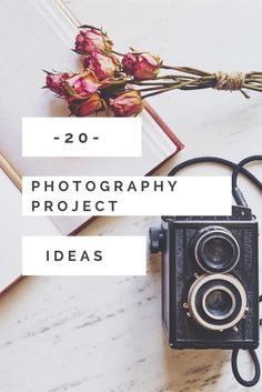 an old camera sitting on top of a table next to a book and some flowers