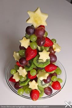 a christmas tree made out of fruit on a plate