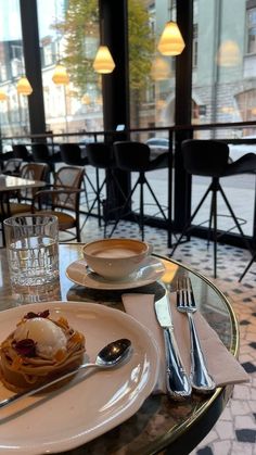 two plates with food and silverware on a table in a restaurant or bar area