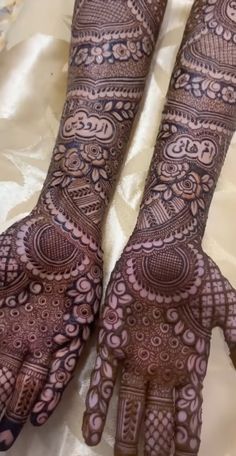 two hands with henna designs on them